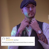 a man with tattoos is adjusting his tie