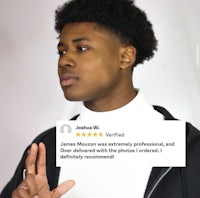 a young man with a black hoodie is making a gesture with his hands