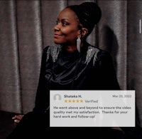 a woman is sitting in front of a screen with a thumbs up