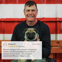 a man holding a pug in front of an american flag